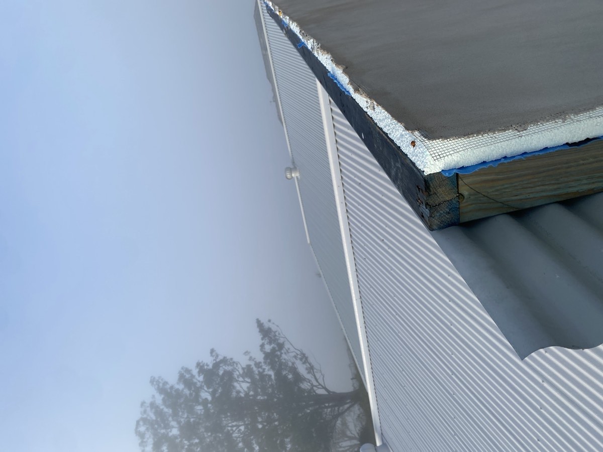 Sarking to parapet capping, recorded during a lock-up inspection in Box Hill